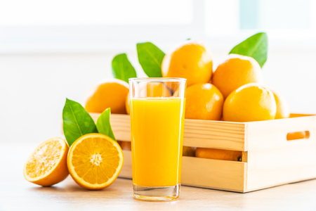 Fresh orange juice for drink in glass on wooden table - Healthy food conceptの写真素材