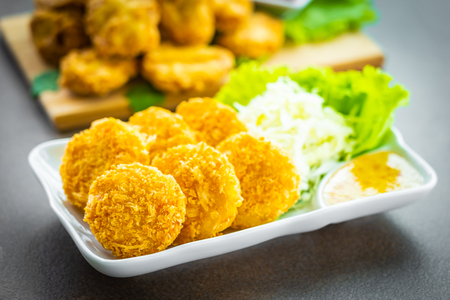 Deep fried crispy shrimp or prawn cake with vegetable and sweet sauce in white plate - Thai food styleの写真素材
