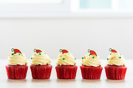 Sweet dessert with cupcake red velvet and chocolate christmas hat on topの写真素材