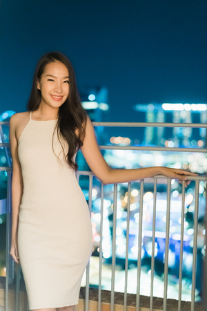 Beautiful Asian women smile and happy with  city view at nightのeditorial素材