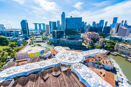 Beautiful architecture building exterior cityscape in Singapore city skyline with white cloud on blue skyの写真素材