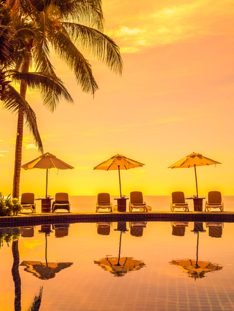 Umbrella and chair around luxury outdoor swimming pool in hotel and resort for vacation and travelの写真素材