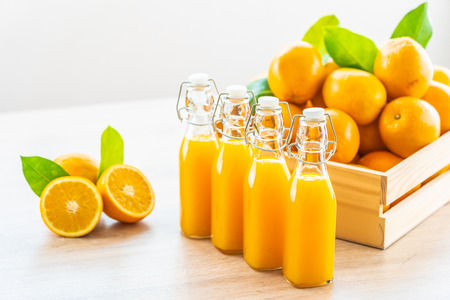 Fresh orange juice for drink in bottle glass on wooden table - Healthy food conceptの写真素材