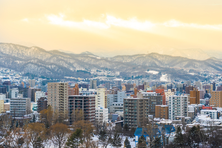 Beautiful architecture building with mountain landscape in winter season at sunset time Sapporo city Hokkaido Japanのeditorial素材