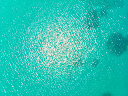 Aerial view of sea and ocean water reflection with sun light for backgroundの写真素材