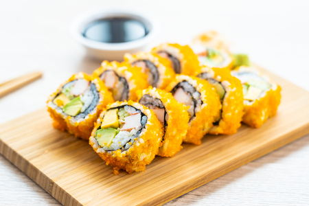 California maki rolls sushi on wooden plate with sauce and chopsticks - Japanese food styleの写真素材