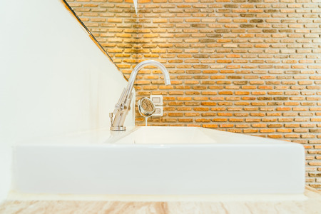 Faucet or water tap and white sink or washbasin decoration in bathroom interiorの写真素材
