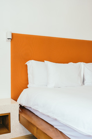 Beautiful comfortable white pillow and blanket on bed decoration in bedroom interiorの写真素材