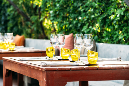 Wine glass with dining set prepare for breakfast lunch or dinner on table in restaurant and cafeの写真素材
