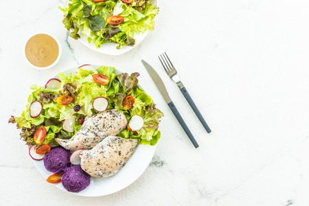 Grilled chicken breast meat steak with fresh vegetable in white plate - Healthy food styleの写真素材