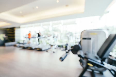 Abstract blur and defocused fitness equipment in gym room interior for background