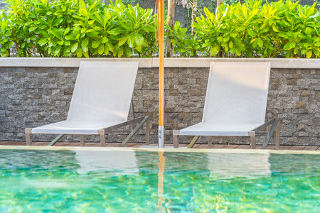 Outdoor swimming pool with umbrella chair lounge around there for leisure travel and vacation conceptの写真素材