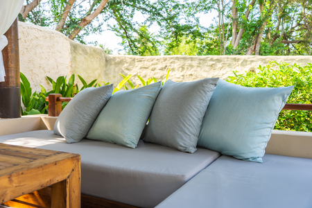 Pillow on sofa chair decoration outdoor patio with garden view for relax and leisureの写真素材