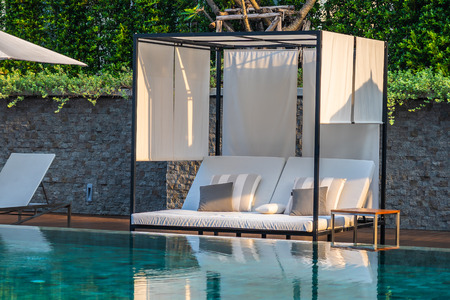 Outdoor swimming pool with umbrella chair lounge around there for leisure travel and vacation conceptのeditorial素材