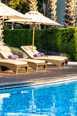 Beautiful outdoor swimming pool with bed deck chair and umbrella in resort for travel and vacation conceptのeditorial素材