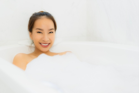 Portrait beautiful young asian woman relaxing bathtub in bathroom interior