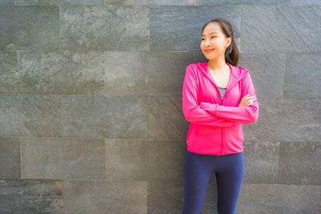 Portrait asian woman in sport wear with smile and ready for workout and exercisingの写真素材