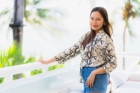 Portrait beautiful young asian woman happy and smile with travel in hotel resort neary sea and beach for vacation and travelの写真素材
