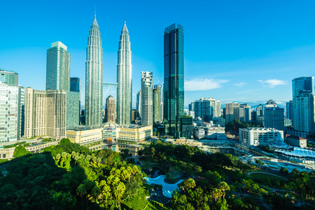 Beautiful architecture building exterior city in kuala lumpur skyline with white cloud and blue skyのeditorial素材