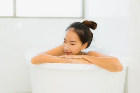 Portrait beautiful young asian woman relaxing bathtub in bathroom interiorの写真素材