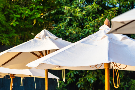 Beautiful outdoor nature landscape with sea ocean and coconut palm tree around swimming pool in hotel resort at sunrsie or sunset for leisure travel and vacationの写真素材