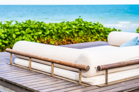 Beautiful outdoor nature landscape with pillow on sofa and lounge around tropical beach sea and ocean in hua hin Thailandの写真素材
