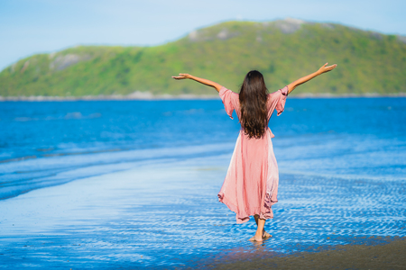 Portrait beautiful young asian woman smile happy walk on the tropical outdoor nature beach sea for leisure vacationの写真素材