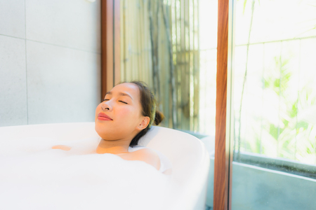 Portrait beautiful young asian woman in the bathtub for take a bath leisure and relaxの写真素材
