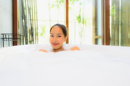 Portrait beautiful young asian woman in the bathtub for take a bath leisure and relax
