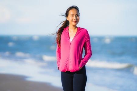 Portrait beautiful young asian woman running or exercise on the tropica nature landscape of beach sea ocean for healthy conceptの写真素材