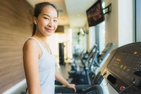 Portrait beautiful young sport asian woman exercise and work out with fitness equipment in gym interior room for healthyの写真素材