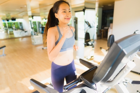 Portrait asian woman exercising and workout by running in gym for healthyの写真素材