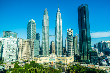 Beautiful architecture building exterior city in kuala lumpur skyline with white cloud and blue skyのeditorial素材