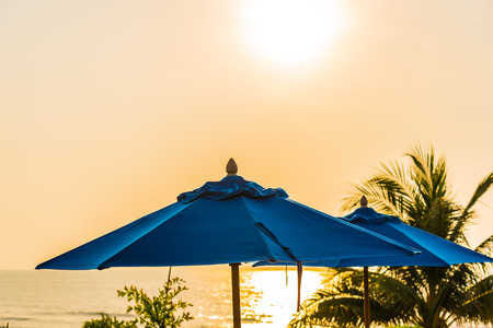 Empty chair and umbrella around swimming pool in hotel and resort for leisure travelの写真素材