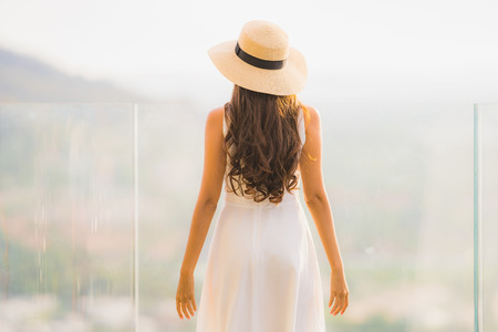 Portrait beautiful young asian woman happy smile relax on the roof top bar for leisure in holiday vacationの写真素材