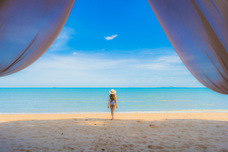 Portrait beautiful young asian woman happy smile relax on the tropical beach sea ocean for leisure travel in holiday vacationの写真素材
