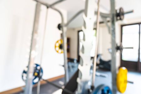 Abstract blur fitness equipment in gym interior room