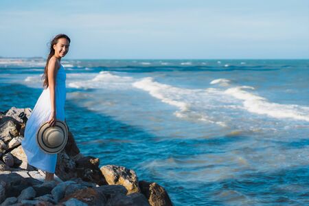 Portrait beautiful young asian woman happy smile relax around neary beach and sea for leisure travel and vactionの写真素材