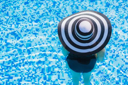 Portrait beautiful young asian woman happy smile relax around swimming pool in hotel resort for leisure travel and vacationの写真素材