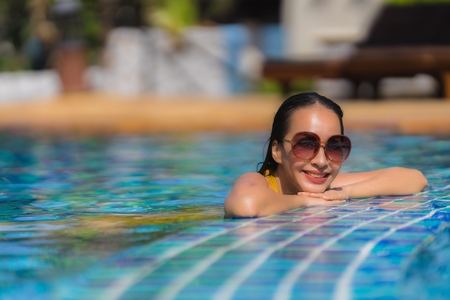 Portrait beautiful young asian woman leisure relax smile and happy around swimming pool in hotel resort for holiday vacation tripのeditorial素材