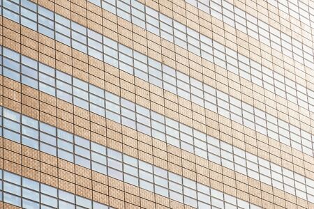 Beautiful architecture office building with glass window textures exterior for backgroundの写真素材