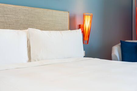 Beautiful comfortable white pillow and blanket on bed decoration in hotel bedroomの写真素材