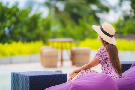 Portrait beautiful young asian woman looking at sea ocean with happy smile for relax leisure in holiday vacationの写真素材