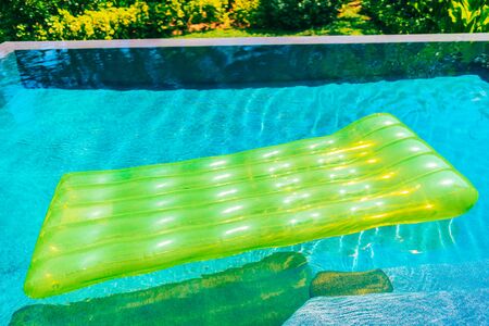 Colorful swim ring or rubber float around swimming pool water for leisure relaxの写真素材