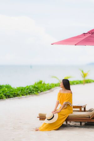 Portrait beautiful asian woman wear hat with smile happy leisure on the beach sea ocean in holiday vacation conceptの写真素材