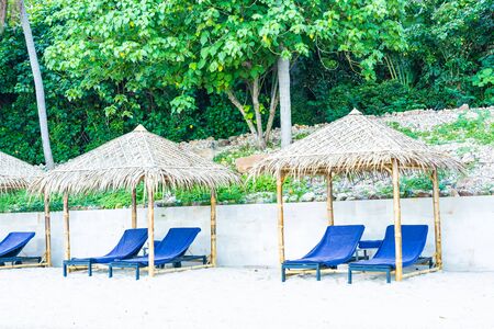 Umbrella and chair on the tropical beach sea and ocean for holiday vacation travel conceptの写真素材