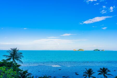 Beautiful outdoor beach sea ocean with coconut palm and other tree around island for travel in holiday vacation conceptの写真素材