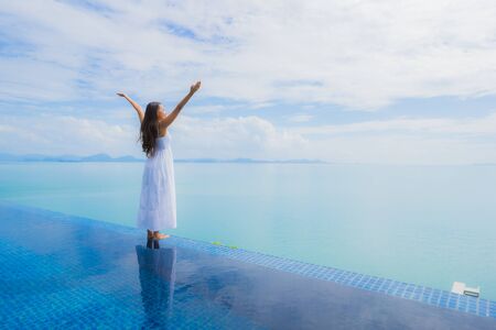 Portrait young asian woman relax smile happy around swimming pool in hotel and resort for holiday...