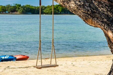 Empty swing seat around beach sea for holiday vacation and travel concept