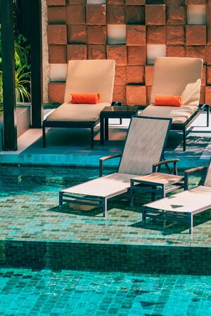 Beautiful outdoor swimming pool with chair and deck for leisure vacation and travelの写真素材